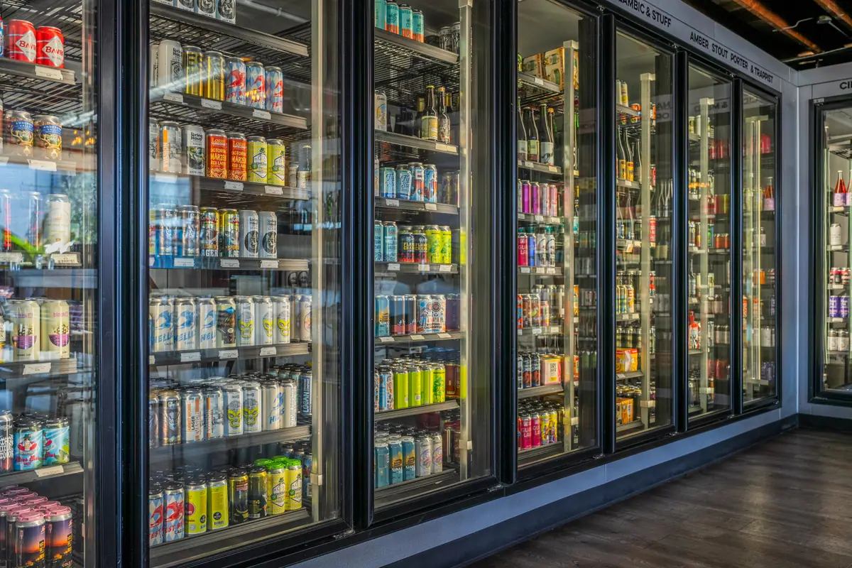 Rows of local craft beer cans in the fourteen-door fridge at Ballard Beer Box in Ballard, Seattle