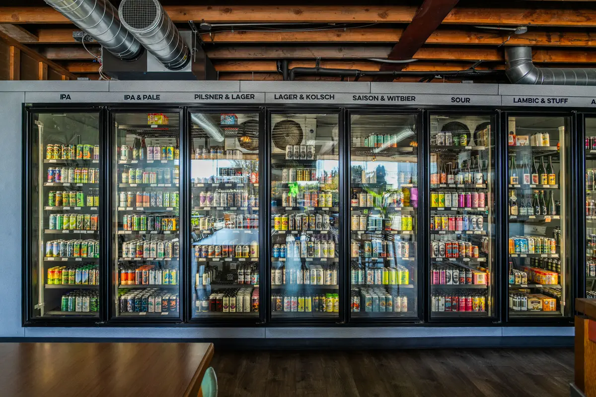 A wall of fridges stocked with craft beer, cider and non-alcoholic drinks at Ballard Beer Box, Seattle