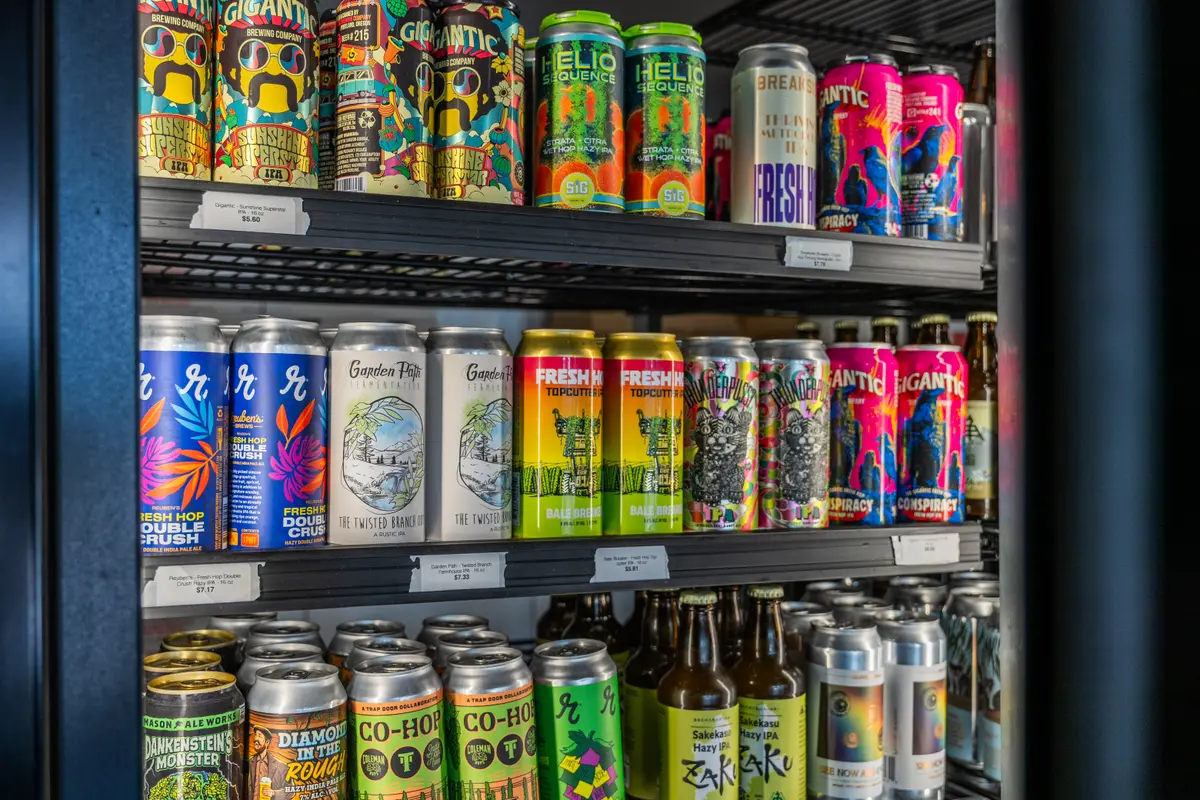 Shelves of craft beer cans from Washington and Oregon breweries in the fridge at Ballard Beer Box, Ballard, Seattle