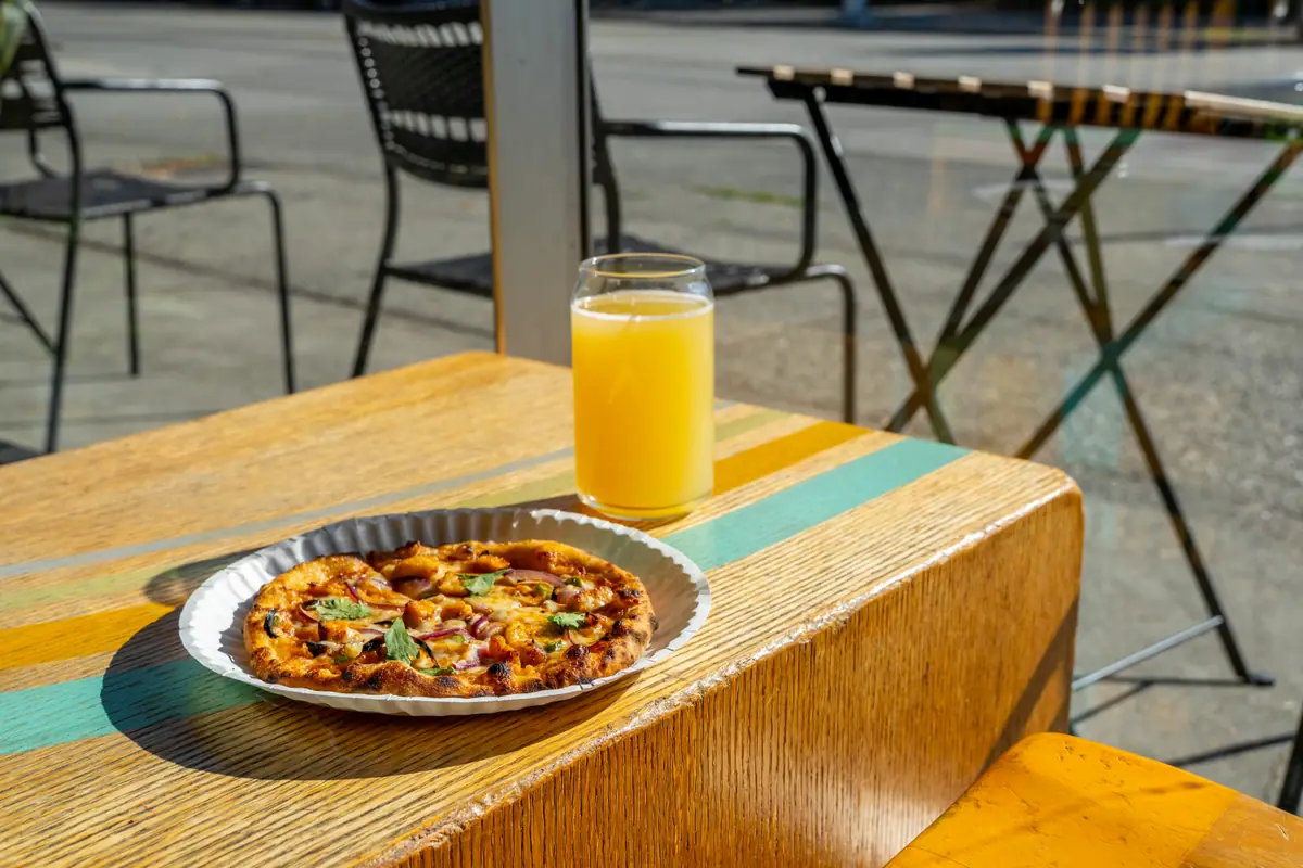 Pizza and a cold drink on the patio at Ballard Beer Box in Ballard, Seattle