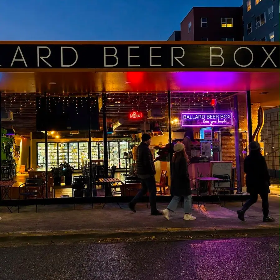 Ballard Beer Box lit up at night on NW Market Street