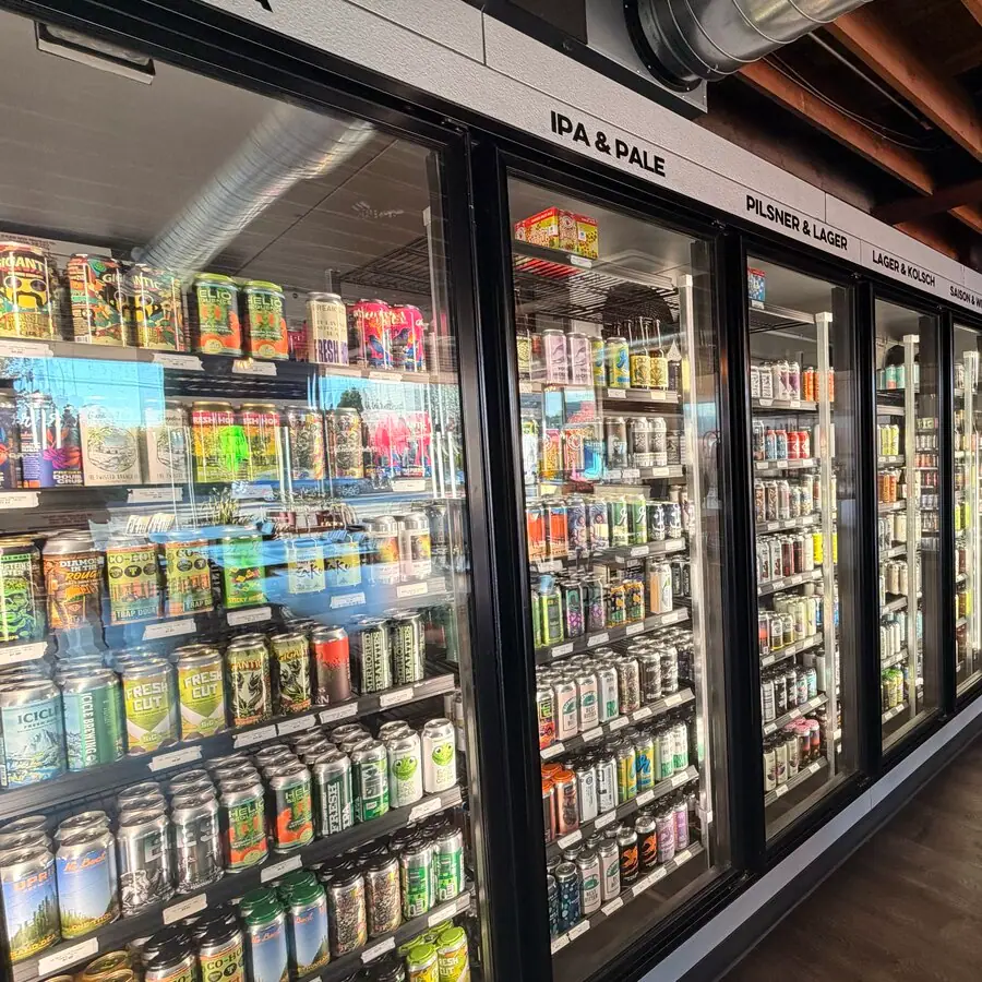 The beer fridge wall at Ballard Beer Box, sorted by style