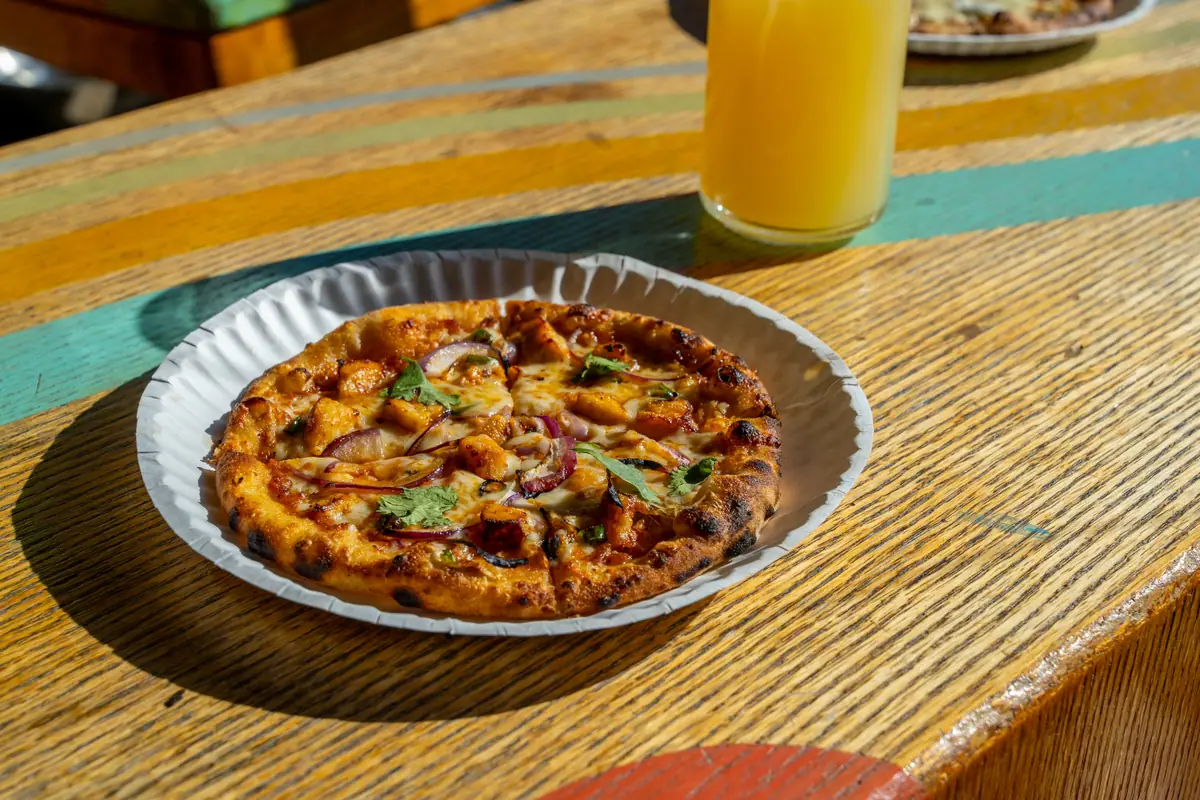 Indian pizza with red onion and cilantro on the patio at Ballard Beer Box in Ballard, Seattle